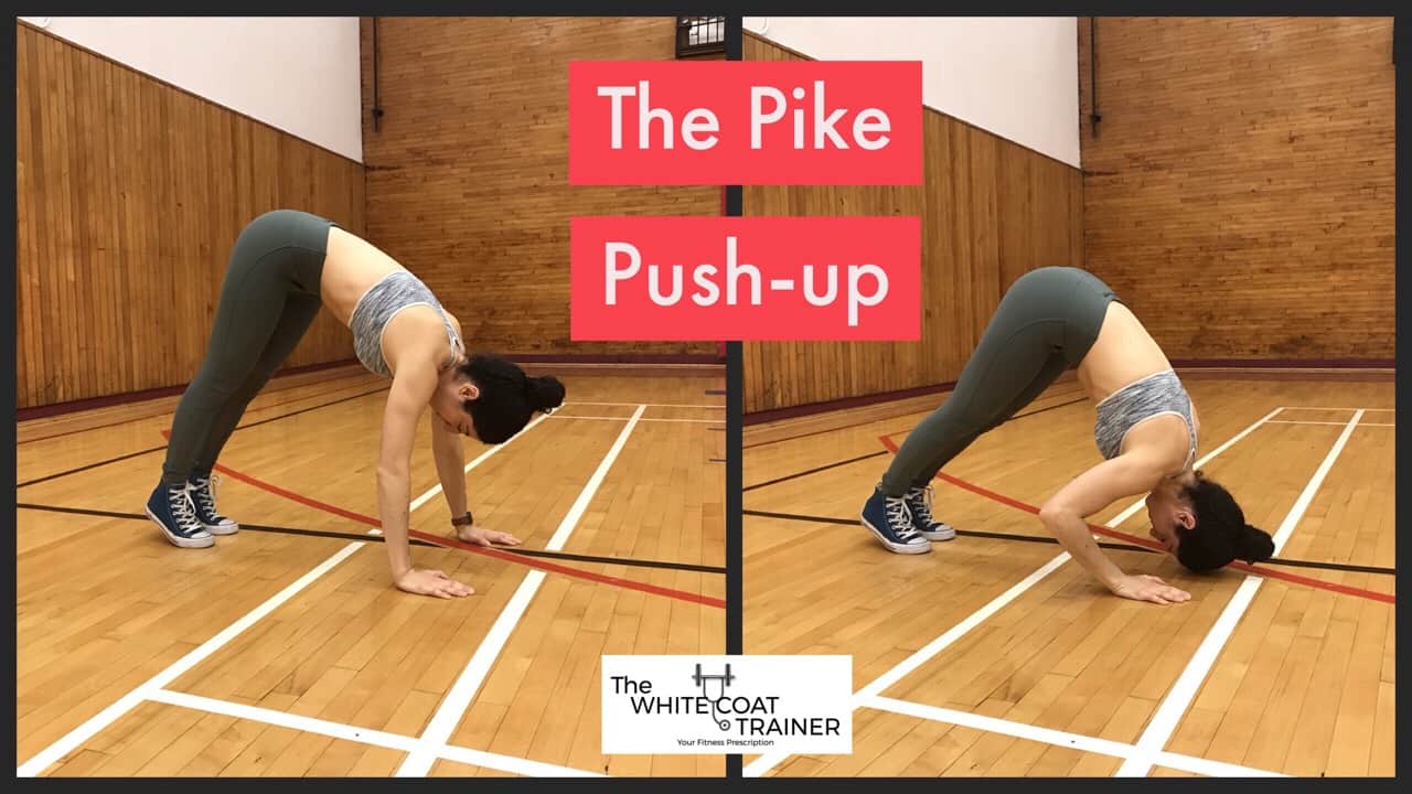 pike-pushup-exercise: Brittany with her hands on the floor, her butt up toward the sky, bringing the crown of her head to the floor by bending her elbows