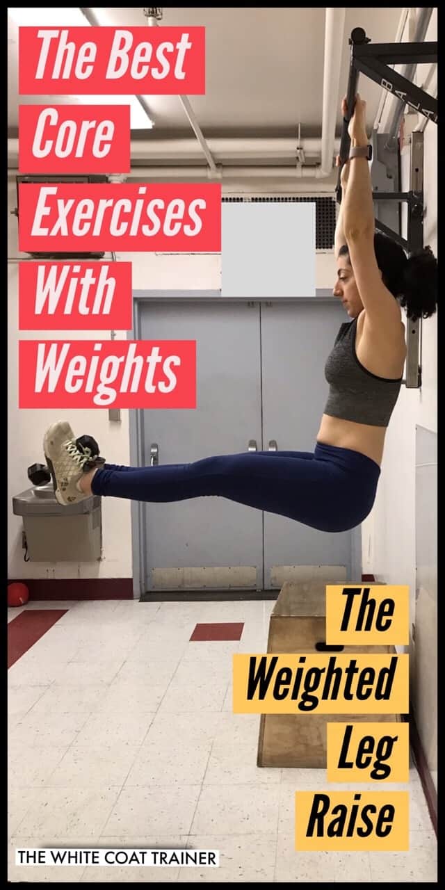 brittany hanging from a pull-up bar with a dumbbell in between her feet and lifting her legs straight up