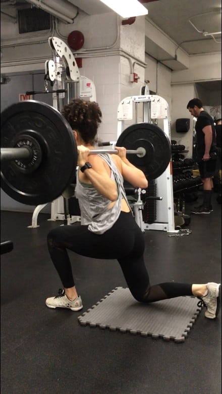 brittany performing a barbell reverse lunge