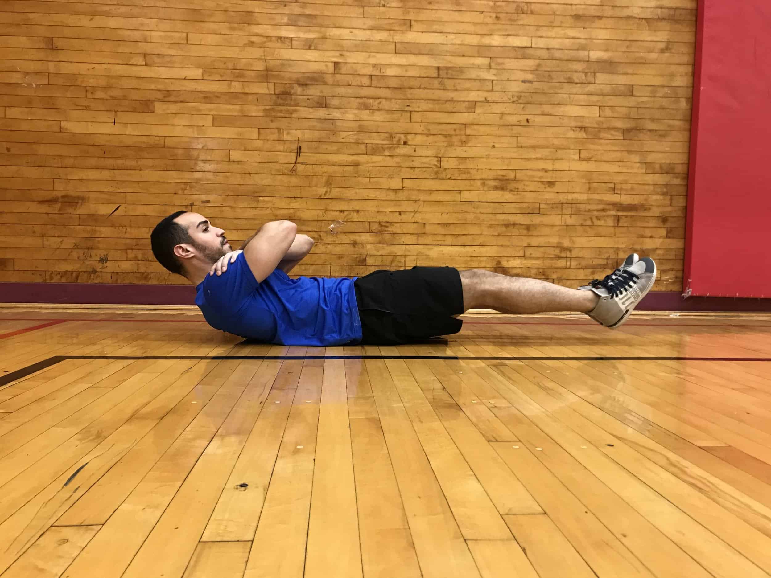 alex showing posterior pelvic tilt while lying on his back (lower back is completely flat on the floor)