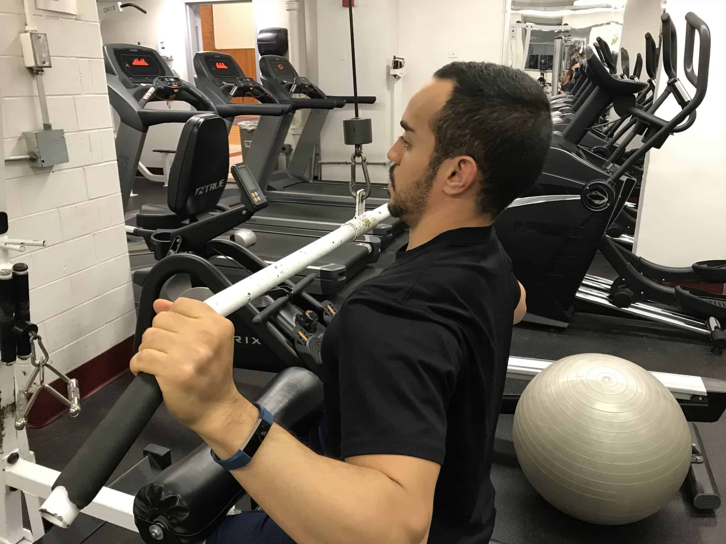 alex doing the lat pulldown incorrectly by letting his shoulders round at the bottom of the exercise