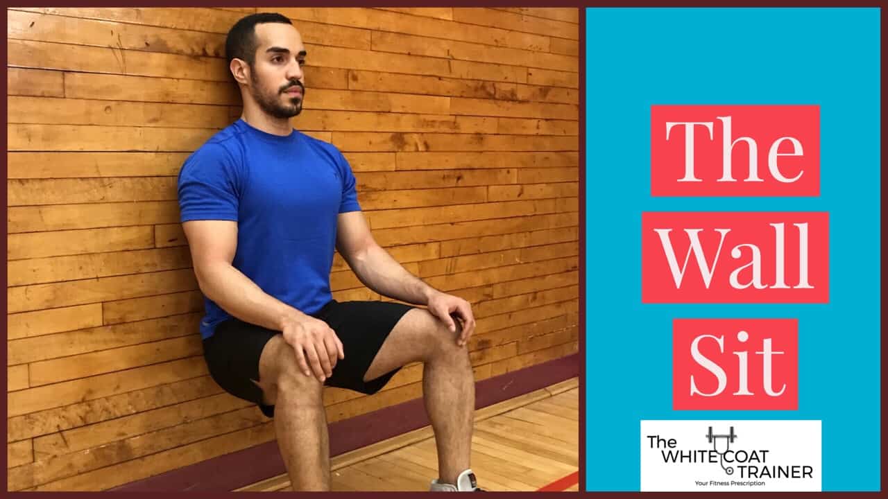 wall-sit: alex with his back flat against a wall with his knees bent to 90 degrees and feet flat on ground 