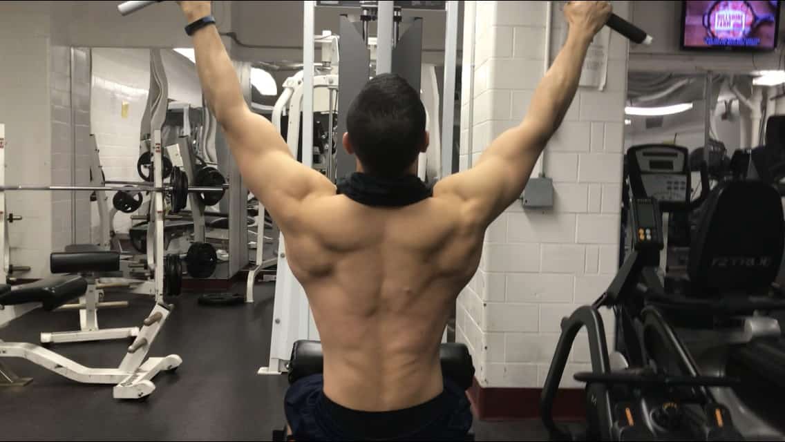 alex on a lat pulldown machine showing back musculature