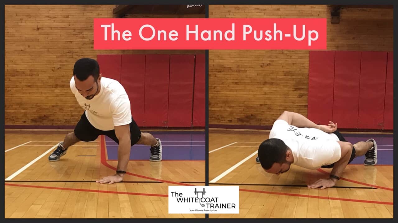 one-hand-push-up-exercise: Alex doing a pushup with one hand: his other hand behind his back and his feet spread wide apart