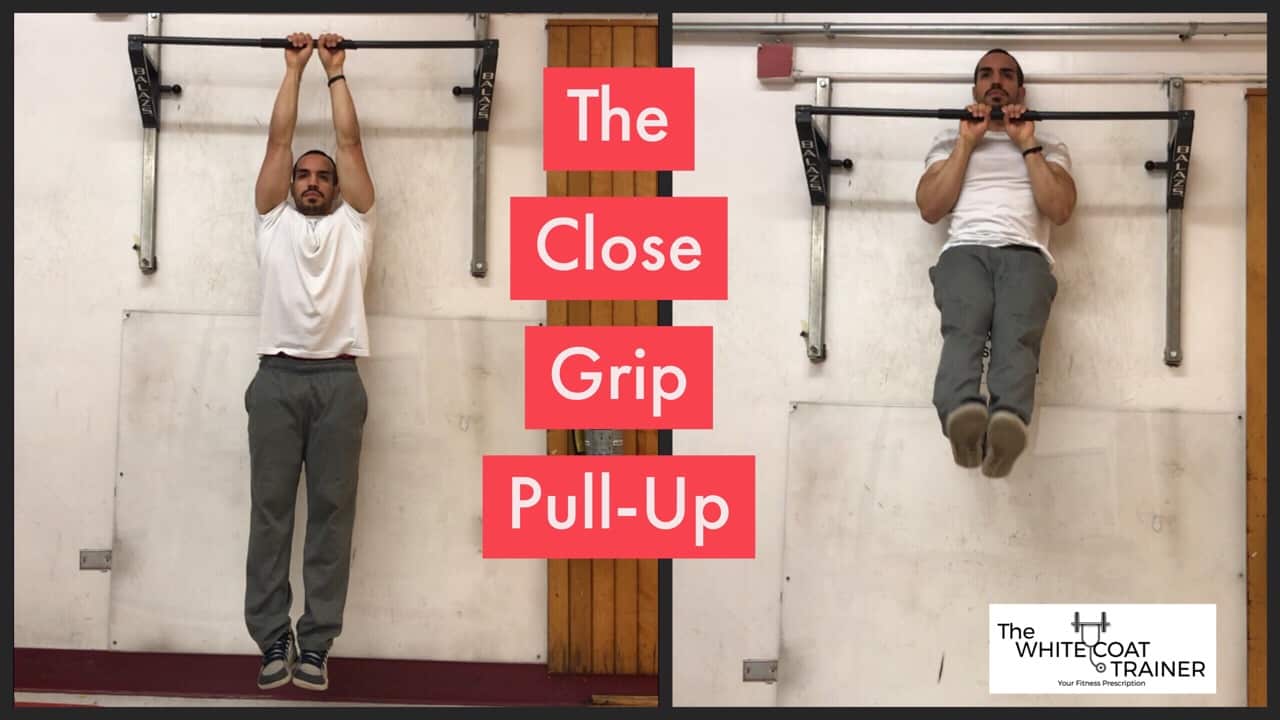 close-grip--pull-up-exercise: alex doing a pullup with his hands close together