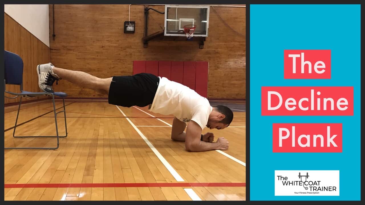 decline-plank: alex in a plank resting on his forearms with his feet elevated on a chair