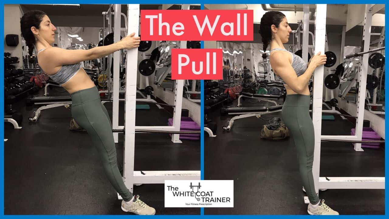 wall-pull-exercise: Brittany standing up and pulling her body towards a vertical beam