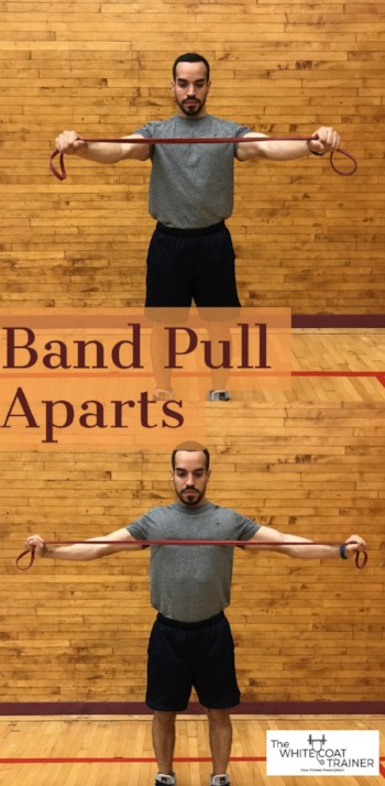 alex holding a band in outstretched arms at chest level and pulling the band apart with straight arms