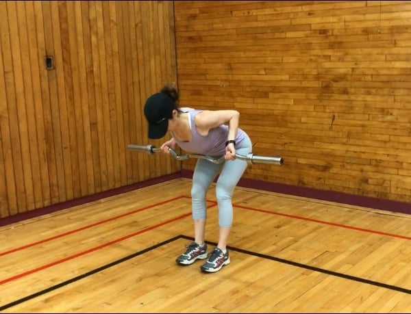 brittany bent over performing a row with an ez-bar