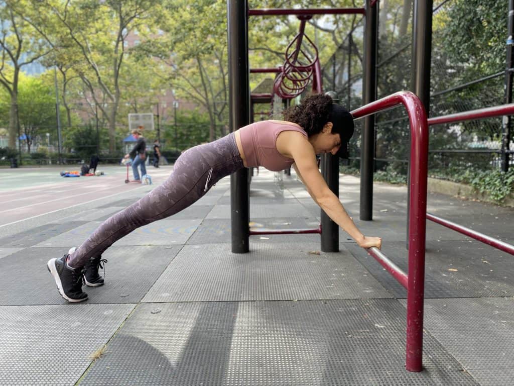 brittany in a plank position with her hands elevated on a higher surface